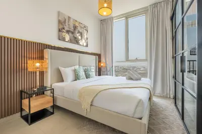 a bedroom with a large bed and a large window at Furnished 1BR Near Dubai Hills Park, Close to the Iconic Dubai Hills Mall, Only 15 Minutes from Burj Khalifa, Collective 20 Tower B, Dubai Hills by Deluxe Holiday Homes in Dubai