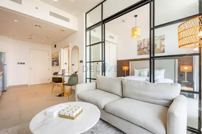 a living room with a couch and a bed at Furnished 1BR Near Dubai Hills Park, Close to the Iconic Dubai Hills Mall, Only 15 Minutes from Burj Khalifa, Collective 20 Tower B, Dubai Hills by Deluxe Holiday Homes in Dubai