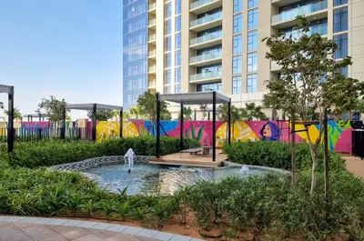 a park in a city with a fountain and buildings at High-Floor Skyline View Near Safa Park and Godolphin Stables with Easy Access to Dubai Mall and Canal, Aykon City 2 Tower C, Business Bay by Deluxe Holiday Homes in Dubai