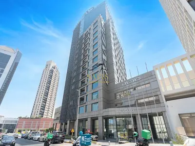 a tall building on a city street with buildings at Savis Homes - The Voleo - Bright and elegant studio - Business Bay in Dubai in Dubai