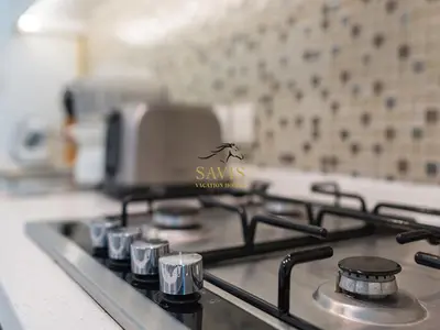 a gas stove top with a logo on it at Savis Homes - The Voleo - Bright and elegant studio - Business Bay in Dubai in Dubai