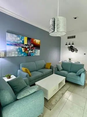 a living room with two blue couches and a white table at Luxury 2 BR Apartment Marina View in Dubai