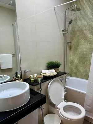 a bathroom with a toilet and a sink and a tub at Luxury 2 BR Apartment Marina View in Dubai