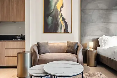 a living room with a couch and a coffee table at Stylish studio Near Downtown Dubai with Pool & Gym Access in Dubai