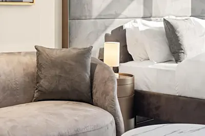a living room with a chair and a bed at Stylish studio Near Downtown Dubai with Pool & Gym Access in Dubai