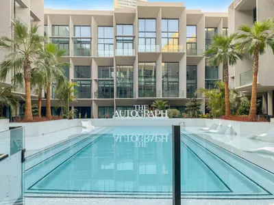a swimming pool in front of a building at Stylish studio Near Downtown Dubai with Pool & Gym Access in Dubai