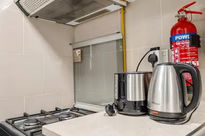 a coffee maker sitting on a counter in a kitchen at FIRST CLASS 1BR Elegant Comfort Awaits in Dubai