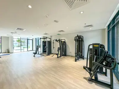 a gym with several tread machines in a room at Studio Apartment near Al Quoz Pond Park in Dubai