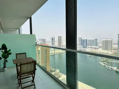 a balcony with a table and a view of the water at Elite & Classy Furnished and Exquisite Living Room in Dubai