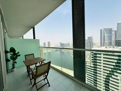 a balcony with a table and a view of the city at Elite & Classy Furnished and Exquisite Living Room in Dubai