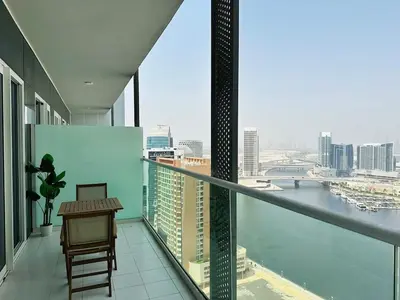 a balcony with a table and a view of the city at Elite & Classy Furnished and Exquisite Living Room in Dubai