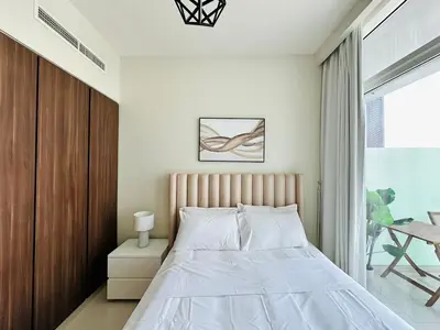 a bedroom with a large bed and a window at Elite & Classy Furnished and Exquisite Living Room in Dubai