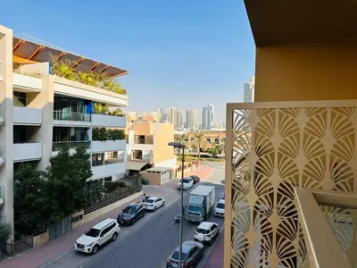 a view of a city street with cars parked on the road at Exclusive Retreat and Spacious Unit in JVC in Dubai