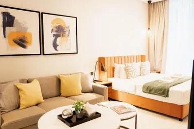 a living room with a bed and a couch at Luxury Studio l Rooftop Pool & Gym Access in Dubai