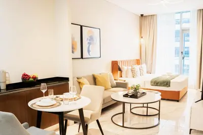 a living room with a couch and two tables at Luxury Studio l Rooftop Pool & Gym Access in Dubai
