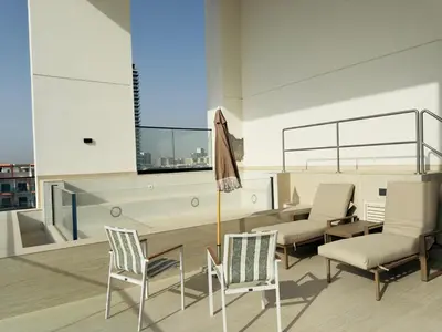 a living room with chairs and a table and a couch at Brand New with Installed Private Pool in Balcony in Dubai