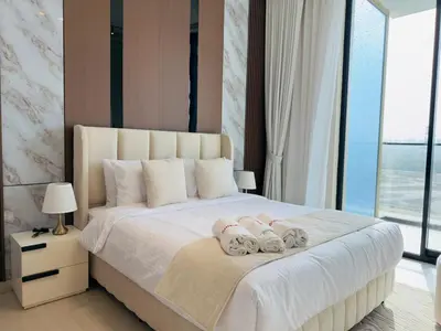 a bedroom with a large white bed with two dolls on it at Brand New with Installed Private Pool in Balcony in Dubai