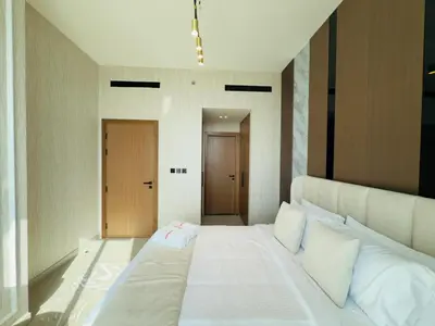 a bedroom with a large white bed with white pillows at Brand New with Installed Private Pool in Balcony in Dubai