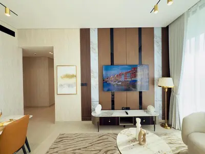 a living room with a couch and a tv on a wall at Brand New with Installed Private Pool in Balcony in Dubai