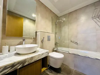 a bathroom with a sink and a toilet and a shower at Cozy Haven High Rise Balcony and Upscale Furnished in Dubai