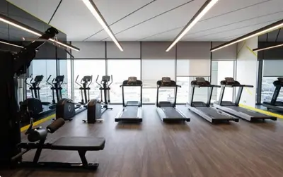a gym with a bunch of treadmills and machines at Cozy Haven High Rise Balcony and Upscale Furnished in Dubai