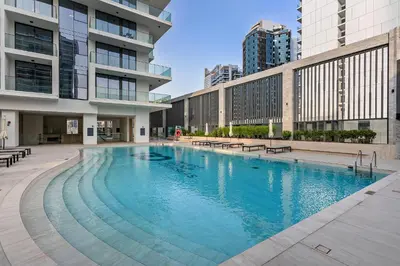 a large swimming pool in the middle of a building at Modern Studio at Paragon with City View in Dubai