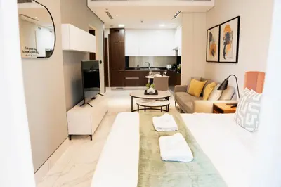 a living room with a couch and a table at Modern Studio in Business Bay l Pool, Gym & Sauna in Dubai