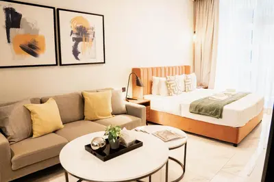 a living room with a bed and a couch at Modern Studio in Business Bay l Pool, Gym & Sauna in Dubai