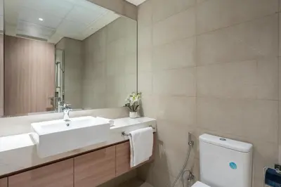 a bathroom with a sink and a toilet and a mirror at GuestReady - Chic & modern studio in Dubai in Dubai