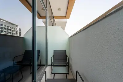 a room with two chairs and a wall at GuestReady - Chic & modern studio in Dubai in Dubai