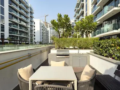 a balcony with a table and chairs and buildings at GuestReady - Chic & modern studio in Dubai in Dubai