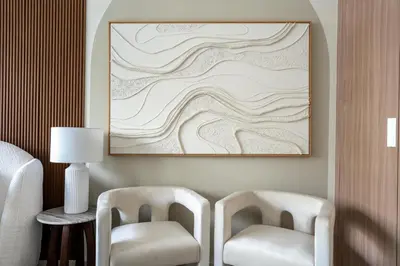 a room with two chairs and a picture on the wall at GuestReady - Chic & modern studio in Dubai in Dubai