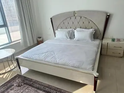 a bed with white sheets and pillows in a bedroom at Stay Inn AlBarsha by PHM in Sabkhah