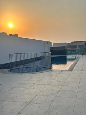 a sunset over a building with a skate park at Stay Inn AlBarsha by PHM in Sabkhah