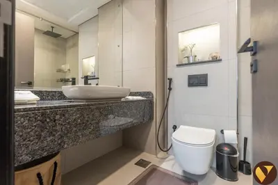 a bathroom with a sink and a toilet and a mirror at Vogue JVC Chaimaa Avenue near Circle Mall, One Bedroom Apartment with Balcony and City View, Access to all Amenities in Dubai
