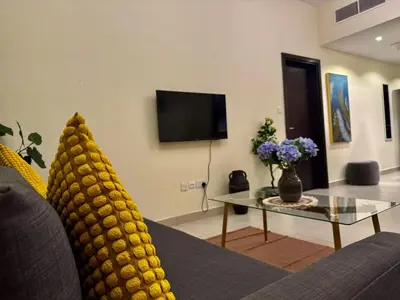 a living room with a couch with a pineapple on the back at Jaddaf NS Building in Dubai