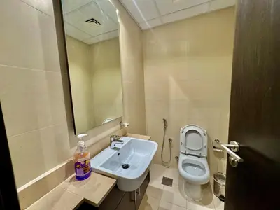 a bathroom with a sink and a toilet at Jaddaf NS Building in Dubai