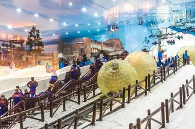 a group of people on a ski slope in a building at Modern & Stylish 1BR, Pool & Gym in Dubai