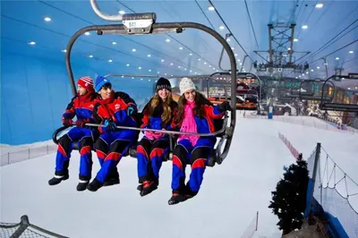 a group of people riding on a ski lift at Modern & Stylish 1BR, Pool & Gym in Dubai