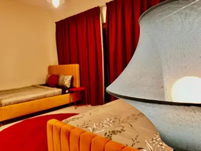 a living room with a bed and a couch at Sandoval Gardens JVC in Dubai
