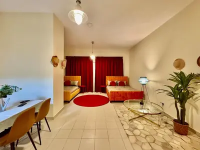 a living room with a couch and a table at Sandoval Gardens JVC in Dubai
