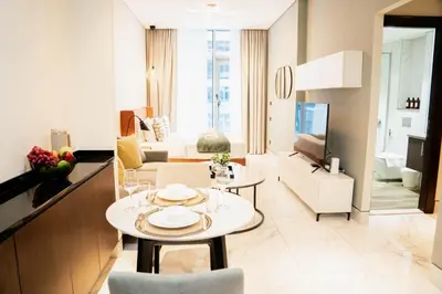a living room with a table and a living room at Chic Business Bay Retreat l Pool, Luxury Amenities in Dubai