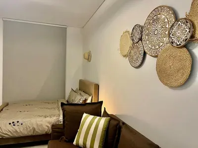 a bedroom with plates on the wall and a bed at Karama stunning unit for 4 in Dubai