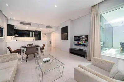 a living room with a couch and a table at Chic Business Bay 1Bed Retreat with Canal Views in Dubai
