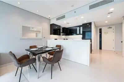 a dining room with a table and chairs at Chic Business Bay 1Bed Retreat with Canal Views in Dubai
