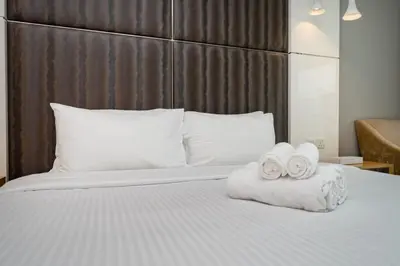 a bedroom with a bed with two towels on it at Chic Business Bay 1Bed Retreat with Canal Views in Dubai
