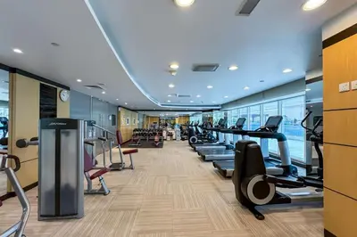 a gym with treadmills and elliptical machines at Chic Business Bay 1Bed Retreat with Canal Views in Dubai