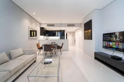 a living room with a couch and a table at Chic Business Bay 1Bed Retreat with Canal Views in Dubai