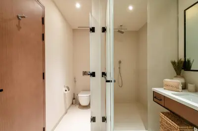 a bathroom with a shower and a toilet and a sink at Seraya Residences at Marina Yacht Club - Vida Marina in Dubai