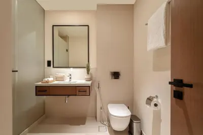 a bathroom with a sink and a toilet and a mirror at Seraya Residences at Marina Yacht Club - Vida Marina in Dubai